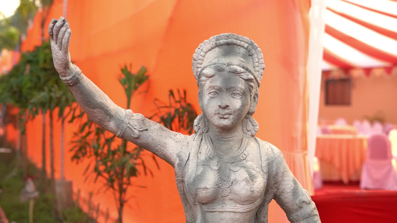 Slow motion shot of a stone statue in front of a wedding banquet