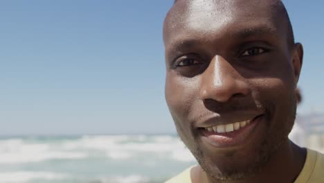 Male-volunteer-looking-at-camera-on-the-beach-4k