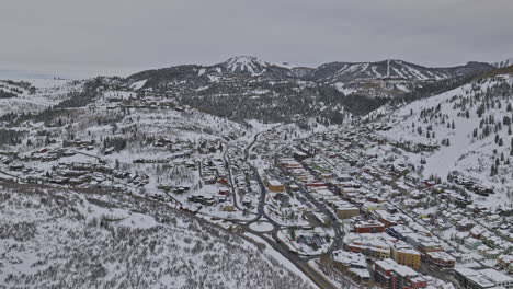 park city utah aerial v72 drone flyover and around downtown capturing hillside homes, ski slopes and wasatch mountains covered in pristine white snow in winter - shot with mavic 3 cine - february 2023