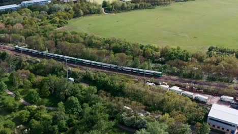 slider drone shot following southern railway class 377 train through north west london