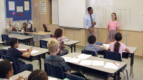 Schoolgirl-answering-question-at-front-of-class,-shot-on-R3D