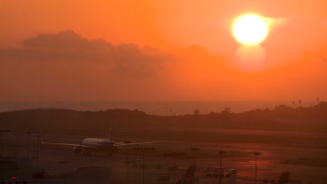 planes taxi at sunset or sunrise at a major metropolitan airport 1