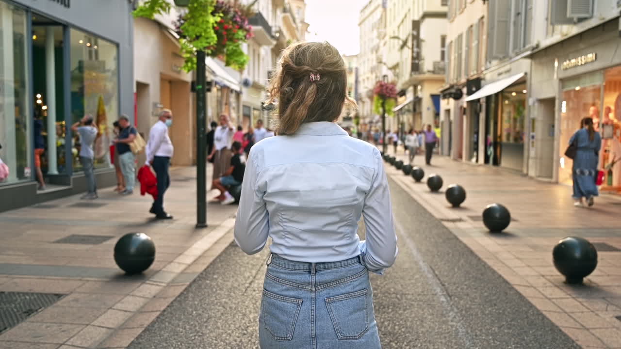 CANNES, FRANCE - AUGUST 28, 2021: Rear view of a walking woman, walking people Slow motion