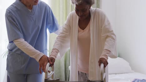 nurse helping a senior woman in a retirement home