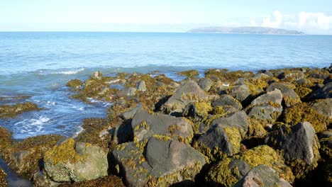 clear blue ocean stone pebble beach coastline island holiday horizon scene
