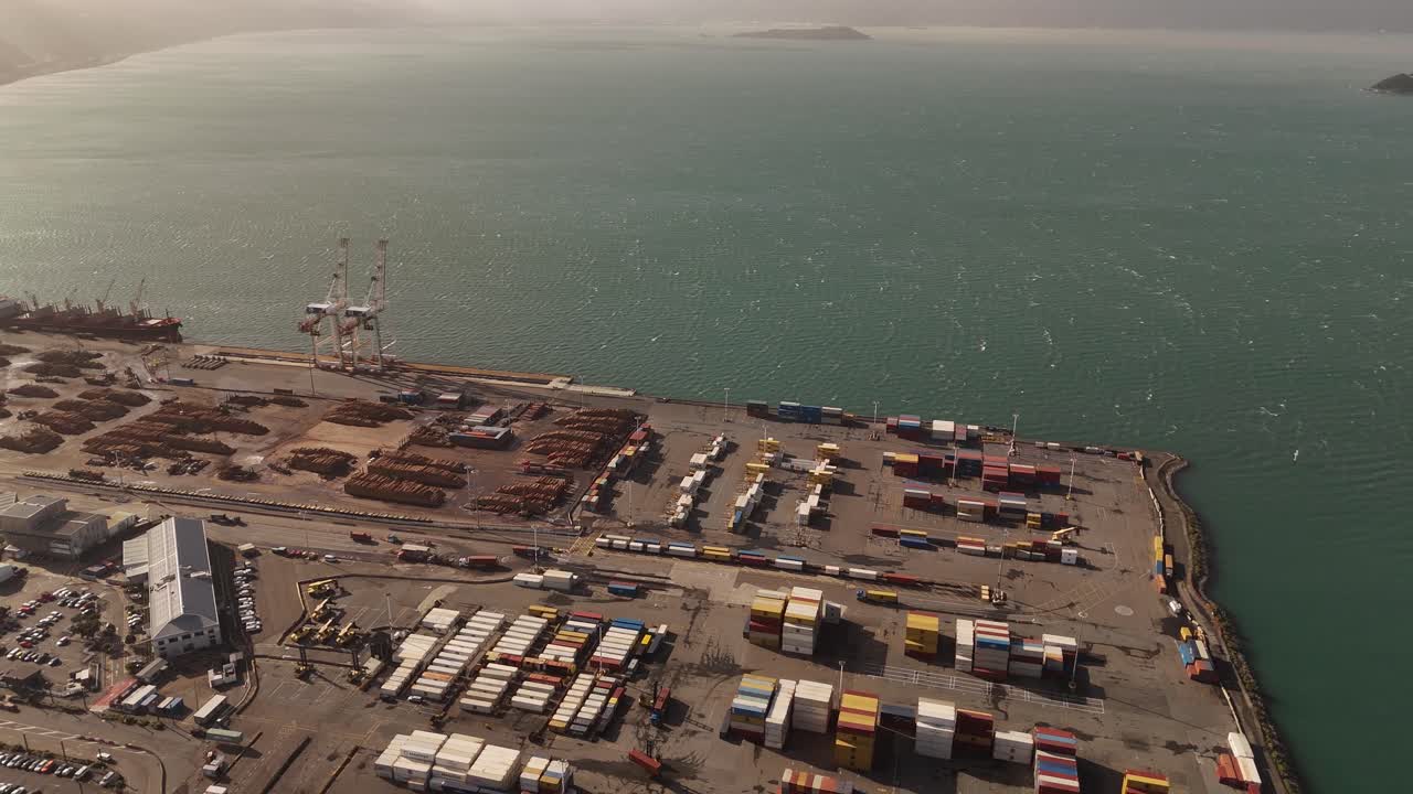 Industrial harbor port of Wellington with cranes and container. Aerial top down shot. Sunset time
