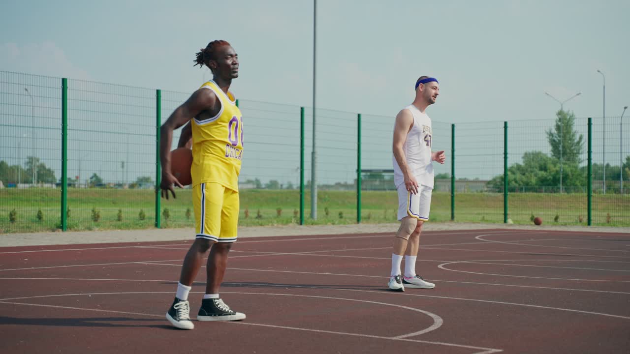 Basketball players on an outdoor court