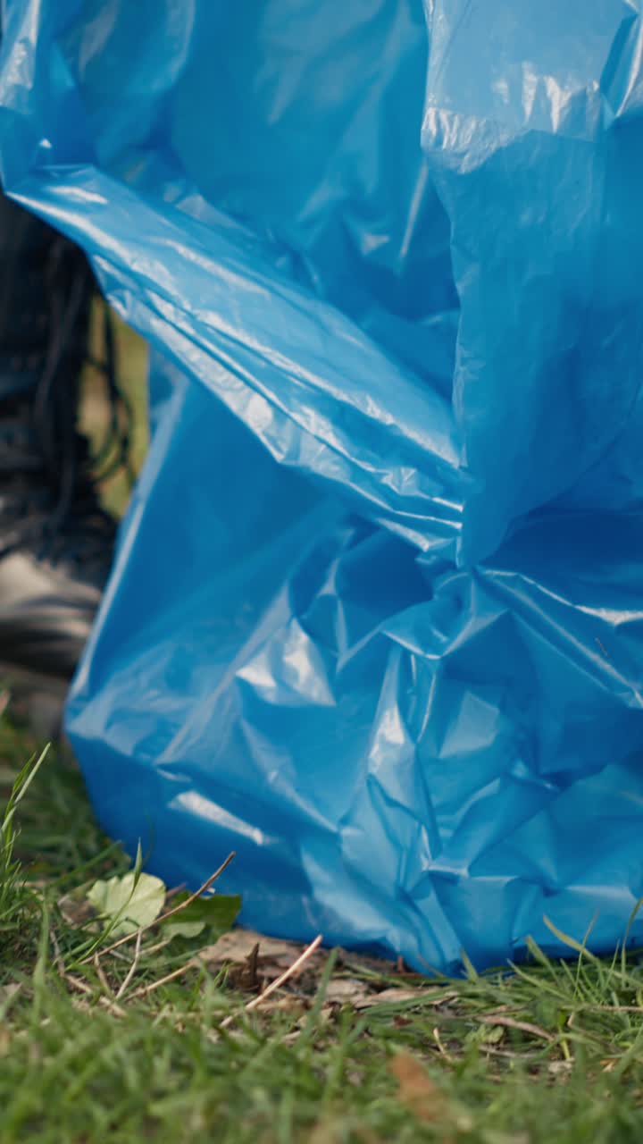 Litter Picker Collecting Plastic Waste from Grass