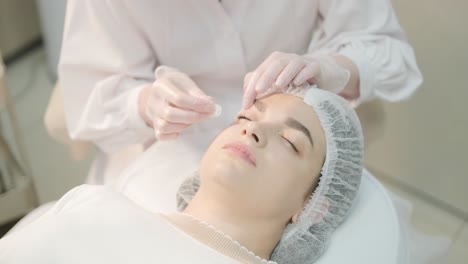 cosmetologist performing facial injection procedure