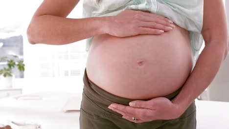 pregnant woman showing her belly