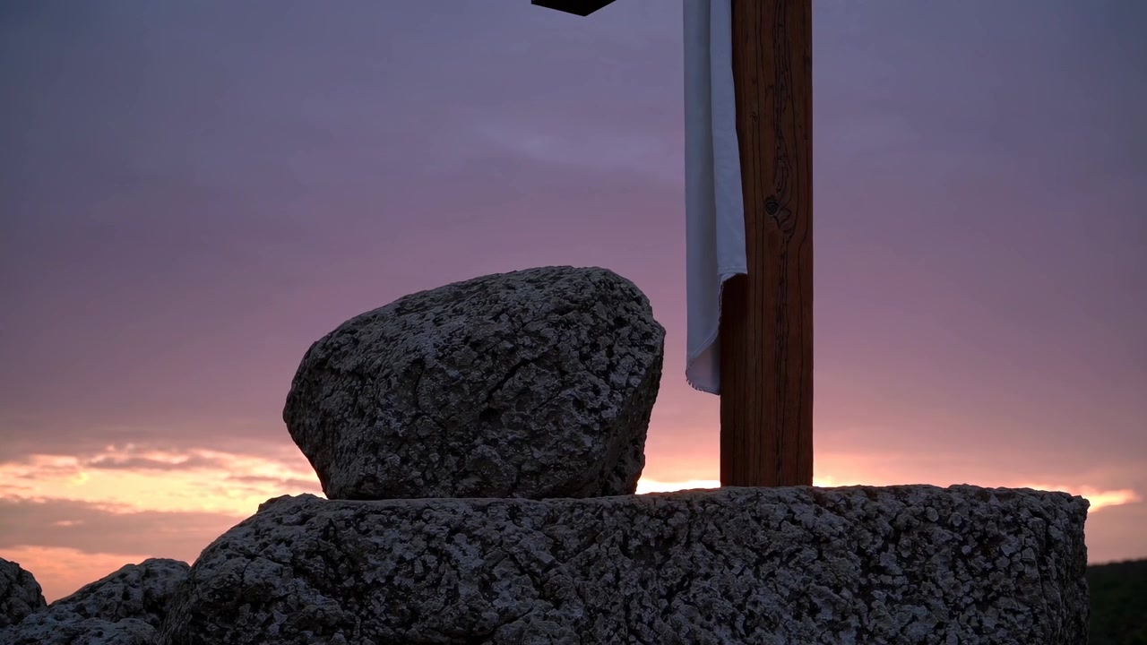 Croce di legno con drappo bianco al tramonto