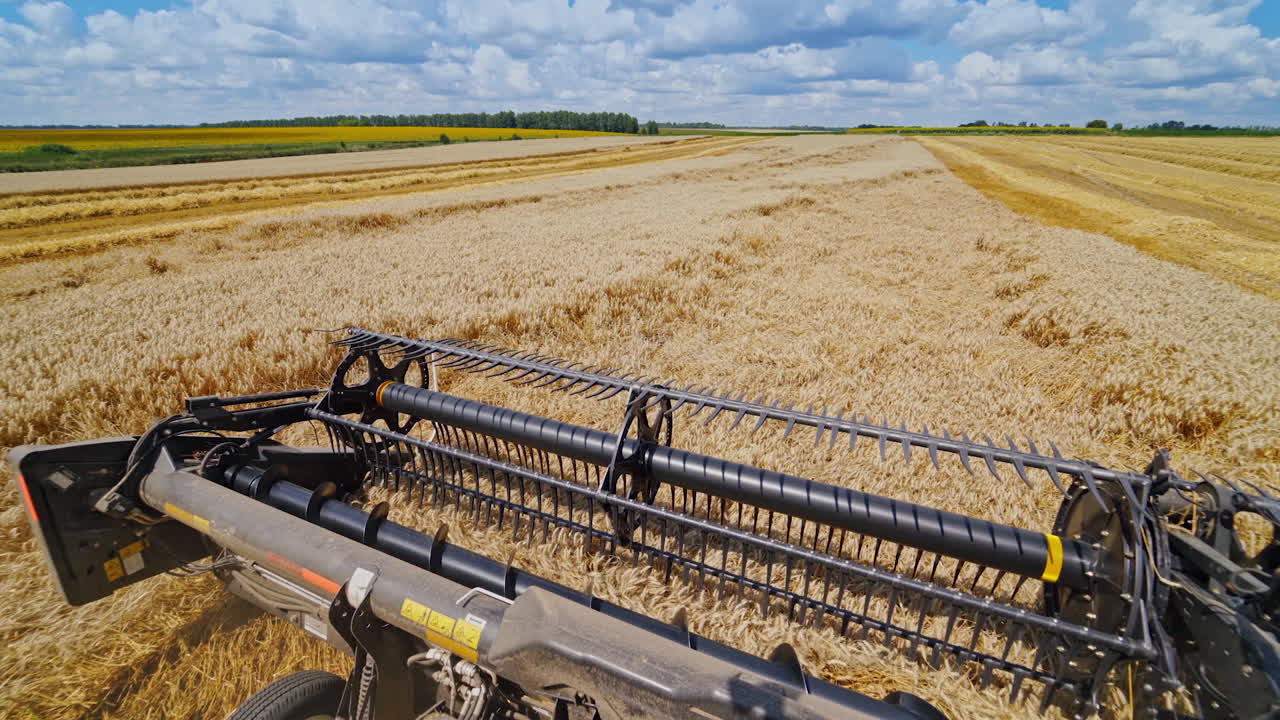 Combine harvester works on a beautiful landscape of nature. Metal part of agricultural machine on the field during seasonal works.