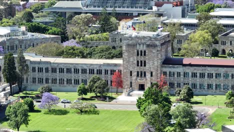 aerial telephoto shot of uq's great court and forgan smith building, with camera drone rotating around main building from a large distance away