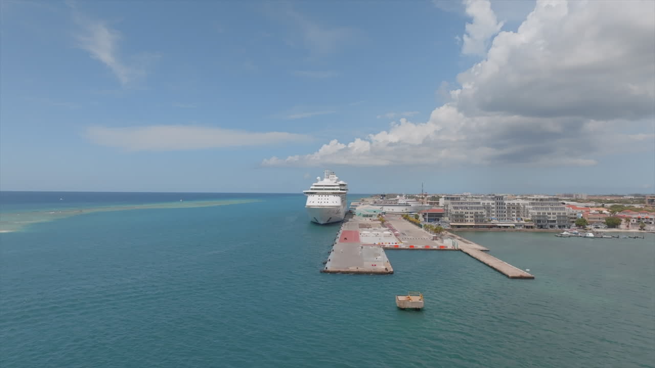 Tropical Caribbean port with luxury cruise liner and blue ocean water