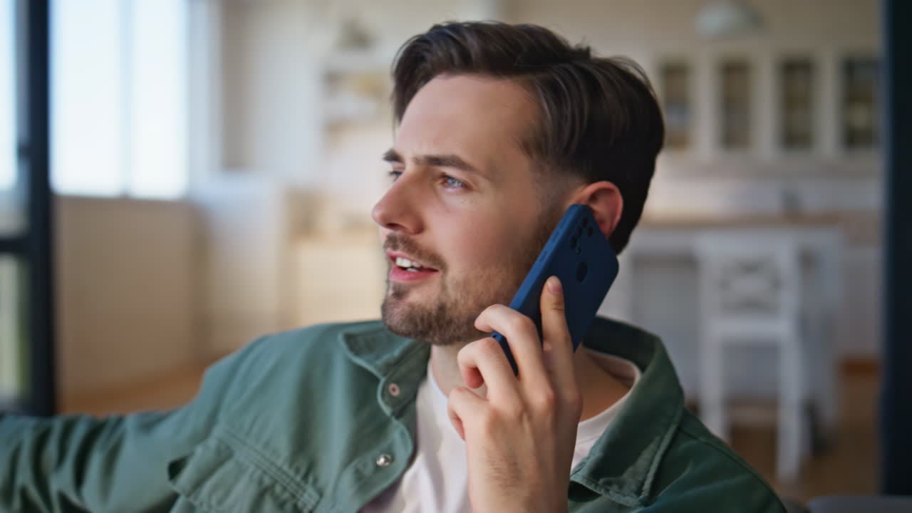 Man hand calling cellphone at cozy studio closeup. Resting guy communicating