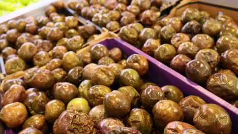 monk fruits arranged in trays at a market