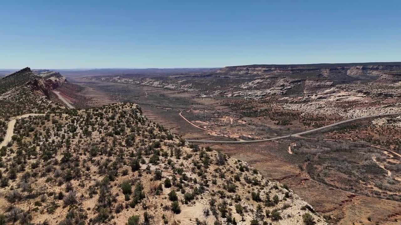 Drone Panning around huge escarpment in the desert. Northern Comb Ridge in Utah. Highway 163