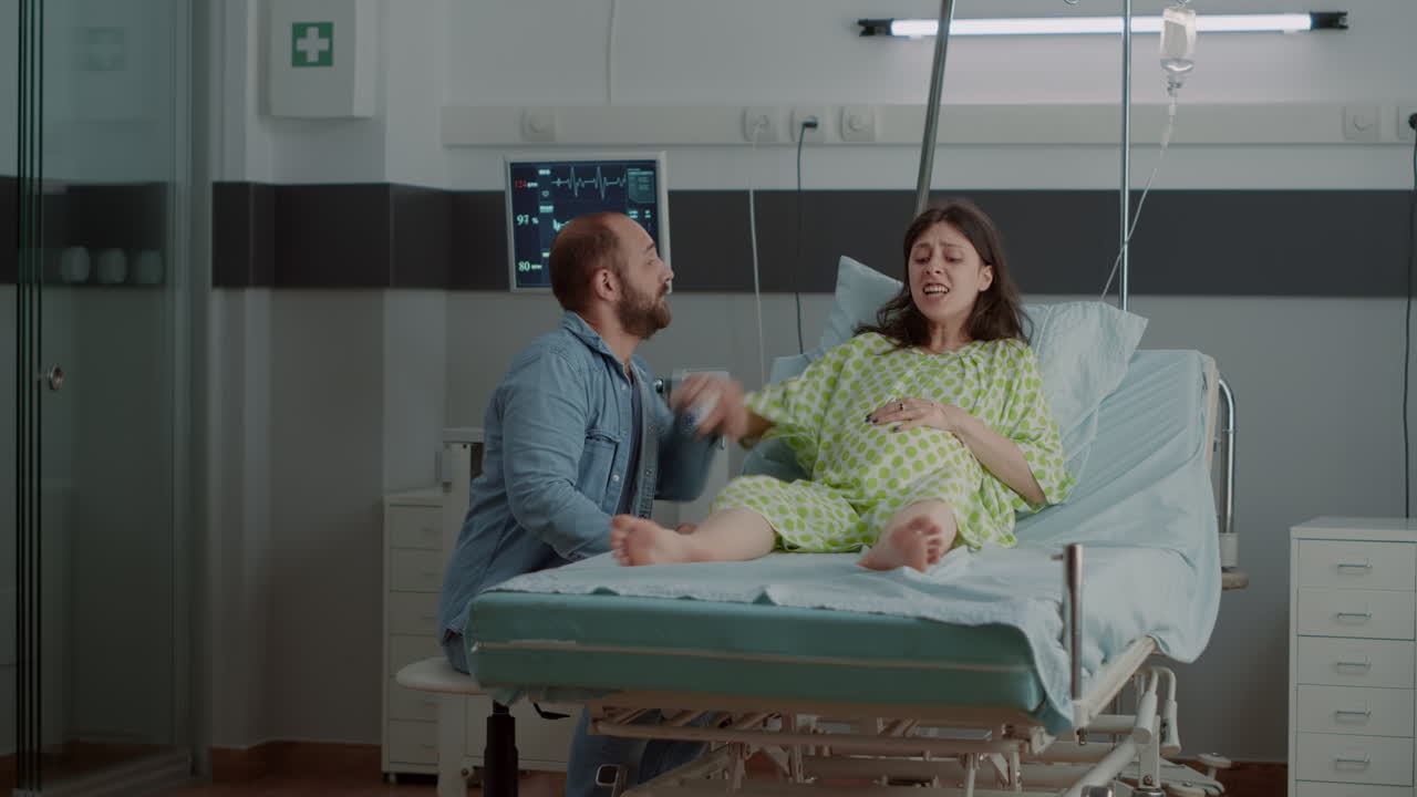 Woman with pregnancy and painful contractions in hospital ward