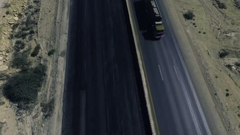 a slow mo aerial top view of a heavy truck moving on a highway in northern areas