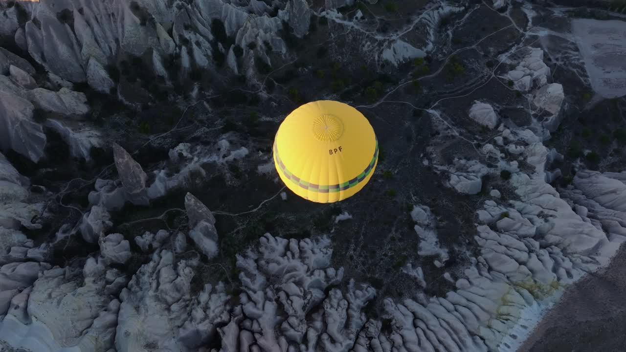 Balloons rising over fairy chimneys in scenic Goreme canyon