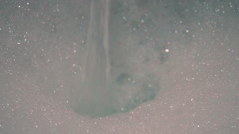 water filling up luxurious bubble bath in bathtub ready to get in and soak into skin after long day. cleaning body to maintain hygiene and cleanliness.