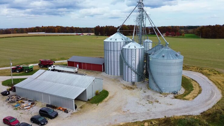 Midwest farm with grain silos and barns, aerial drone