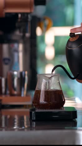 pouring coffee into a glass pot