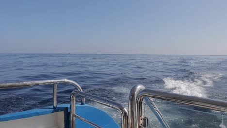 Sea-water-splashes-behind-a-boat-cruising-over-the-waves-on-a-sunny-summer-day,-embodying-the-spirit-of-travel-and-vacation