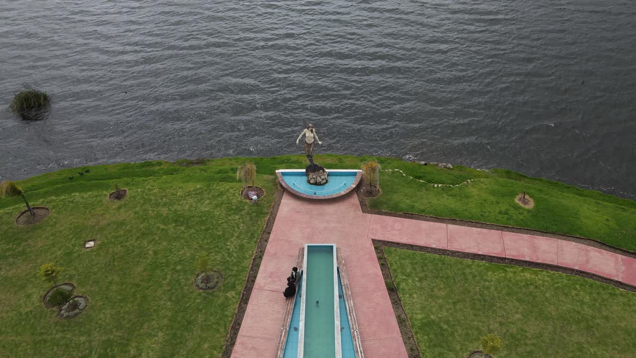 Drone footage of a massive lake in the Andes, capturing crystal waters, dramatic peaks, and the peaceful charm of high-altitude nature