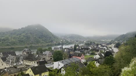 moselle river in germany between forested hills with fog in the morning