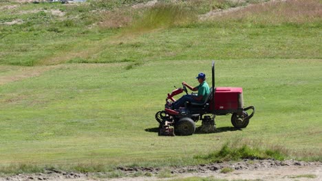 man operating a lawn mower in a field