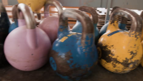a person interacting with a collection of vintage kettlebells