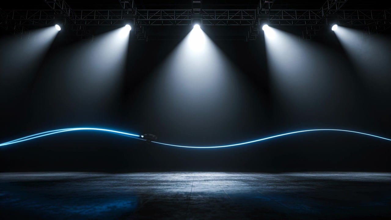 Appearing device rolling along stage under truss and five spotlights, leaving neon-blue wave