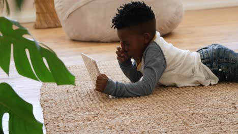 boy using tablet computer at home