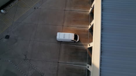 aerial view of a van in a parking lot near a building