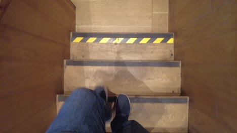 person walking up wooden stairs