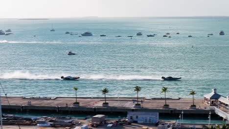 drone tracking a racerboats driving on the coast of key west, sunny florida, usa