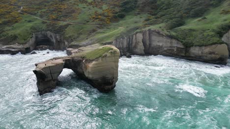 the rock in shape of bridge surrounded by sea