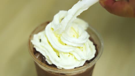 whipped cream being added to chocolate drinks