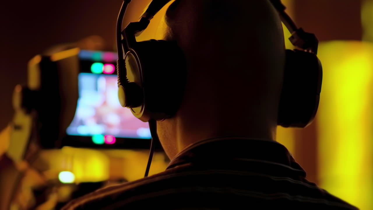 Man filming with professional camera on the backstage of a TV set