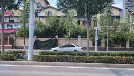 noon traffic hyperlapse drive through shang qiu, henan: cars, bikes, and buildings flashing by to temple in old town