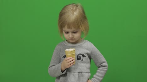 Kid-girl-eat-ice-cream-on-a-Green-Screen,-Chroma-Key