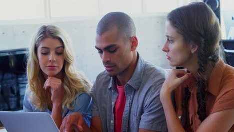 Attentive-colleagues-using-laptop-4k