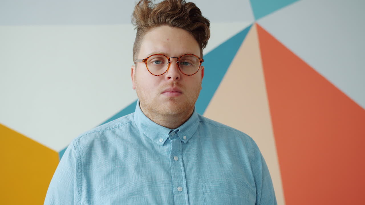 Man wearing glasses and a light blue button-down shirt