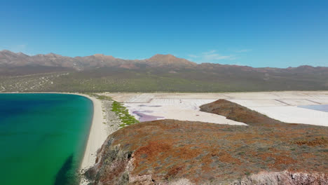 drone pullback shot slowly revealing coastline mountain terrain in baja california sur, mexico