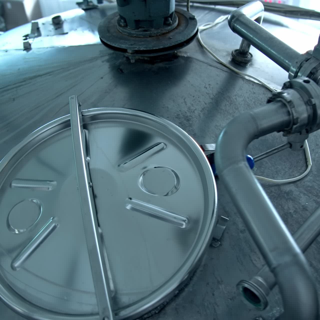 Stainless tank for milk production. Automated equipment on a milk farm. Modern industrial machinery for food processing. Top view