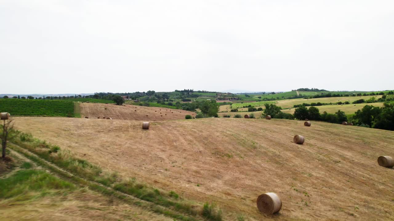 Rolled Hay Bales In A Field In Tuscany Italy - Aerial Drone Shot