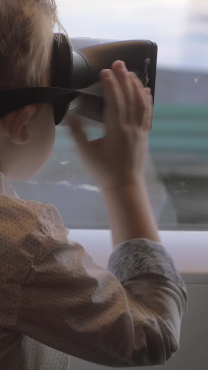 Young Boy Immersed in Virtual Reality Experience with VR Headset