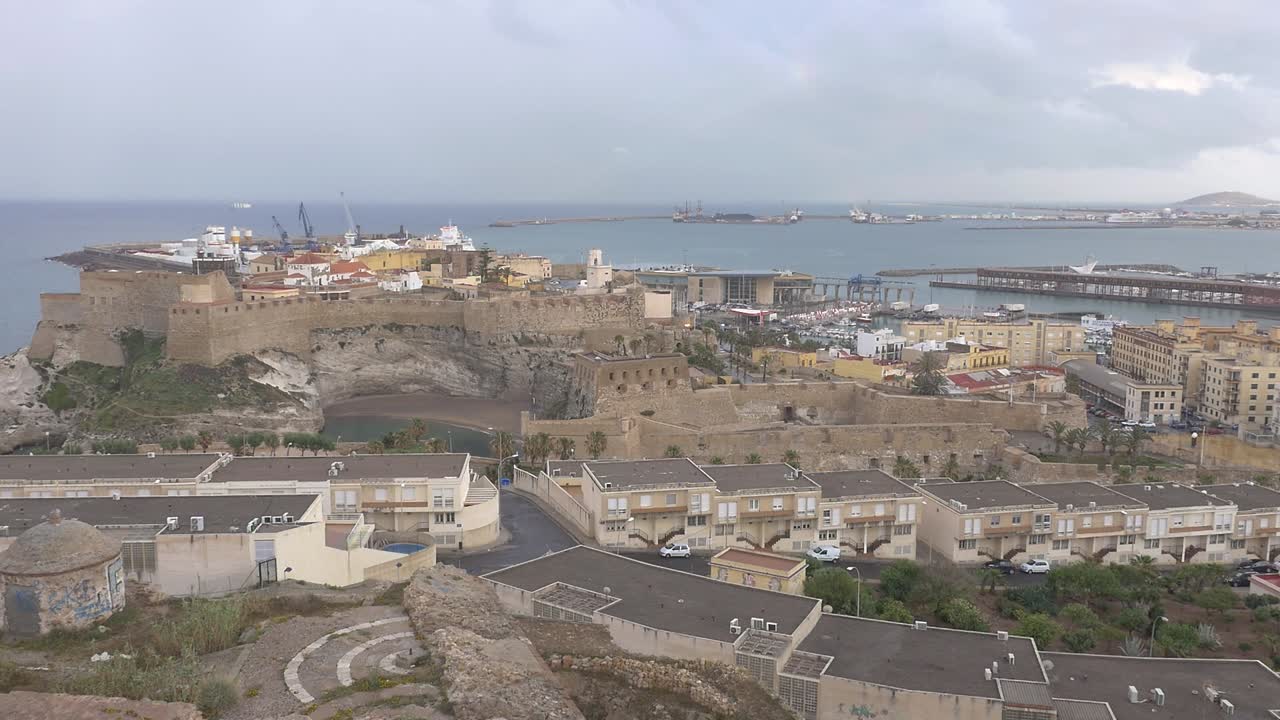 Panoramic view of the fortified citadel of Melilla la Vieja, the beach and the marina, on a cloudy day