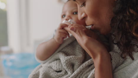 mother holding baby at home calming tired newborn gently soothing restless infant sucking on pacifier loving mom enjoying motherhood